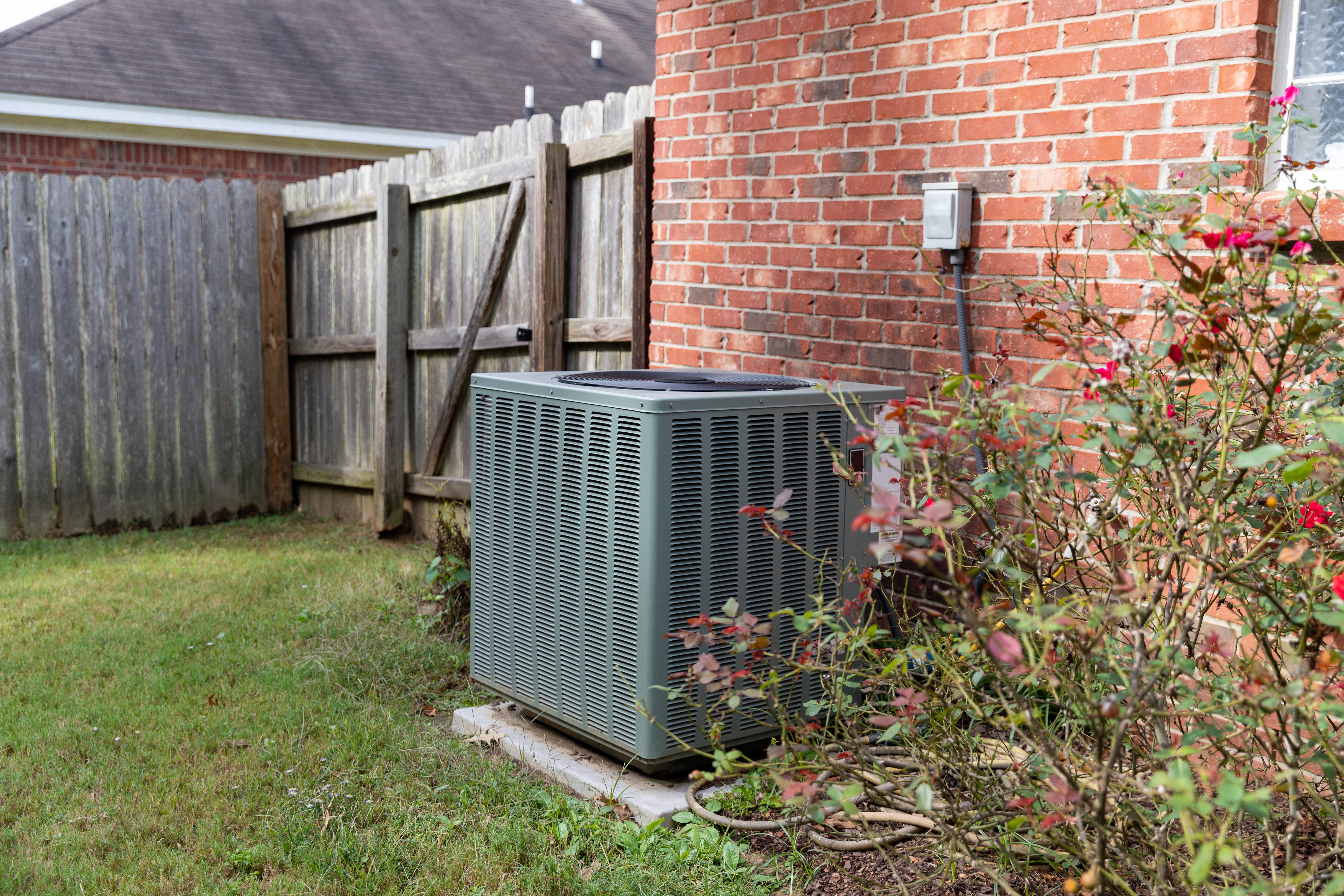 Central Air Units outside of a home in need of repair.