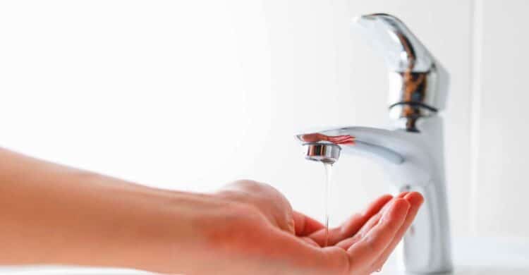 hand gathering water under sink